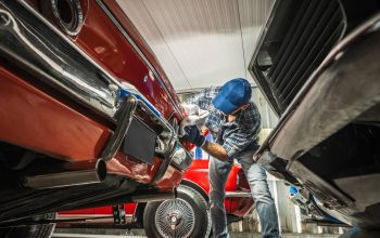 Classic Cars Collector Cleaning The Front Bumper Of His Vehicle.