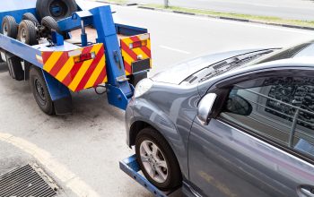 tow-truck-towing-a-broken-down-car-on-the-street